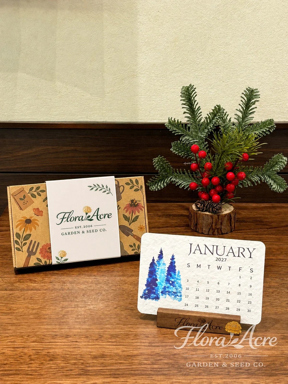 January 2027 calendar card displayed in a wooden stand beside the box